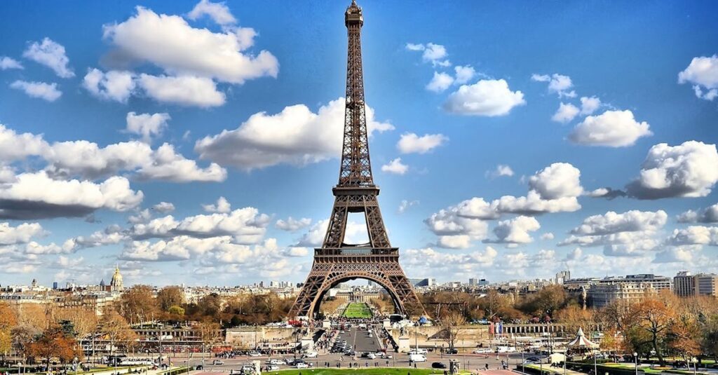 pexels-photo-338515-338515 Stunning view of the Eiffel Tower with a backdrop of fluffy clouds and blue sky in Paris.